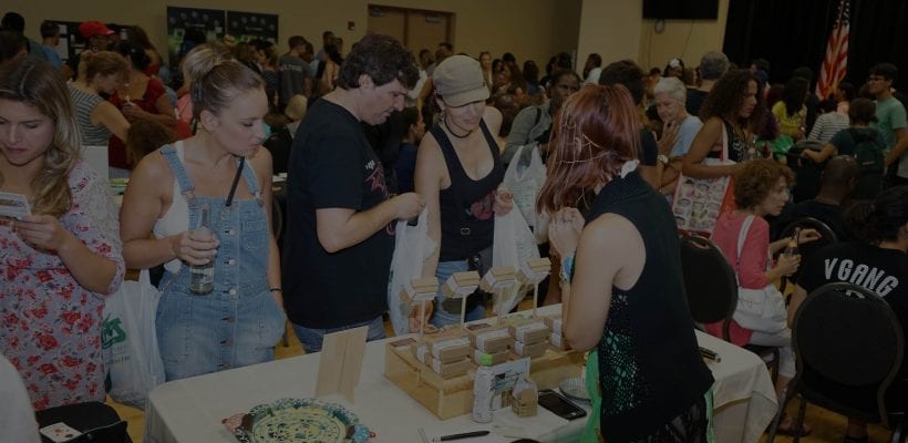 A crowd of people at a vegan convention